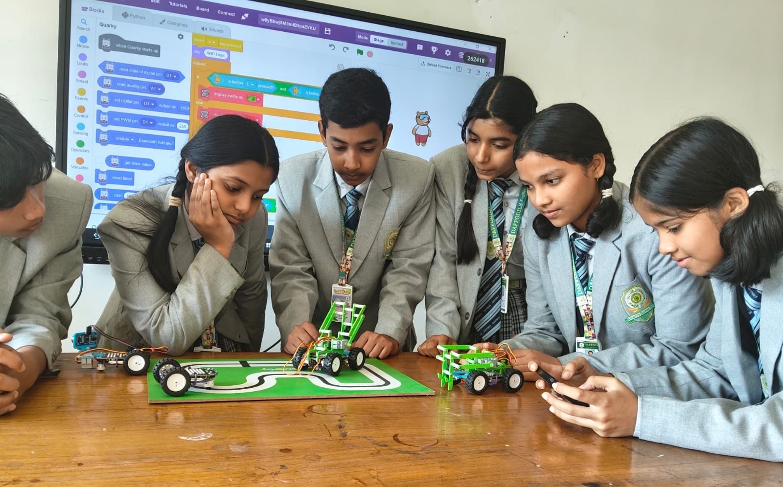 Students programming robot cars in the robotics and coding lab