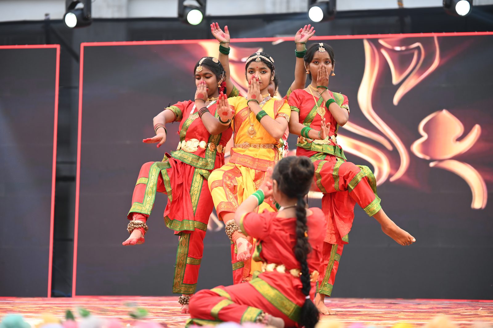 Students in classical dance costume performing on stage