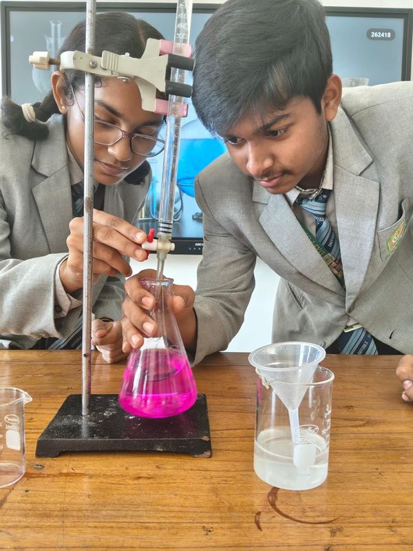 Students carrying out a titration experiment in the chemistry lab