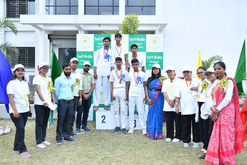 Prize winners on the podium with teachers on sports day