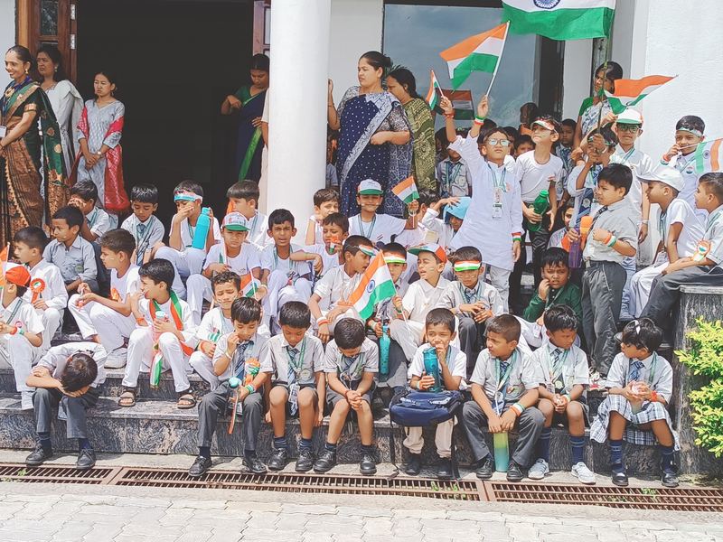 Young students celebrating Independence Day with the national flag