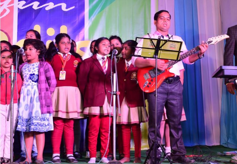Students singing with the school band at the annual function